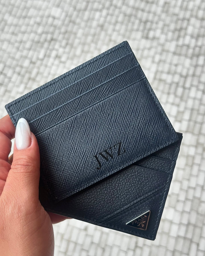 Engraved Prada cardholders — close-up of in-house engraving detail