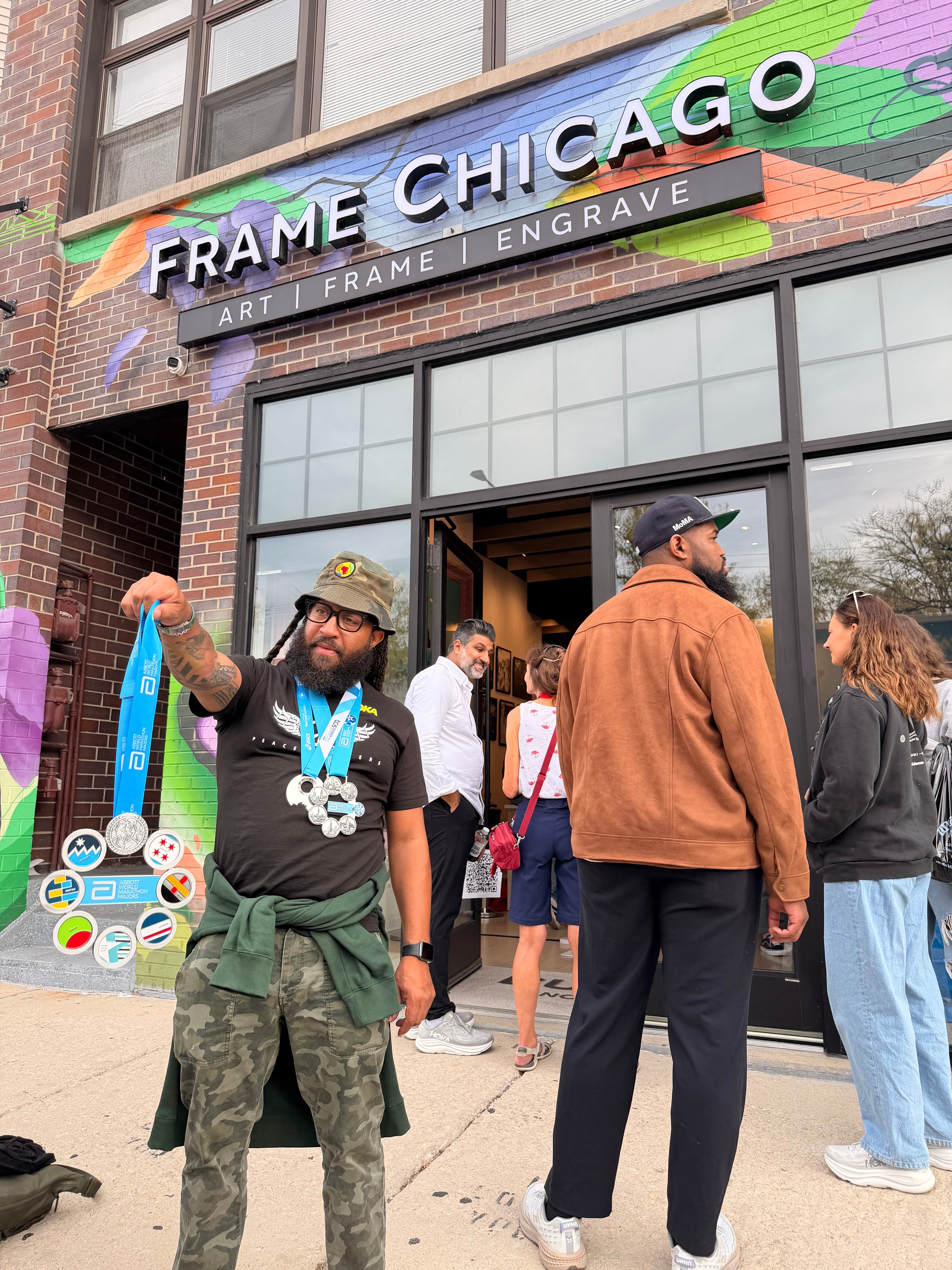 HOKA marathon-weekend activation at Frame Chicago — runner with Abbott World Marathon Majors medals