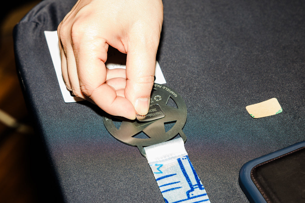 A Chicago 13.1 medal aligned by hand at the engraving bench